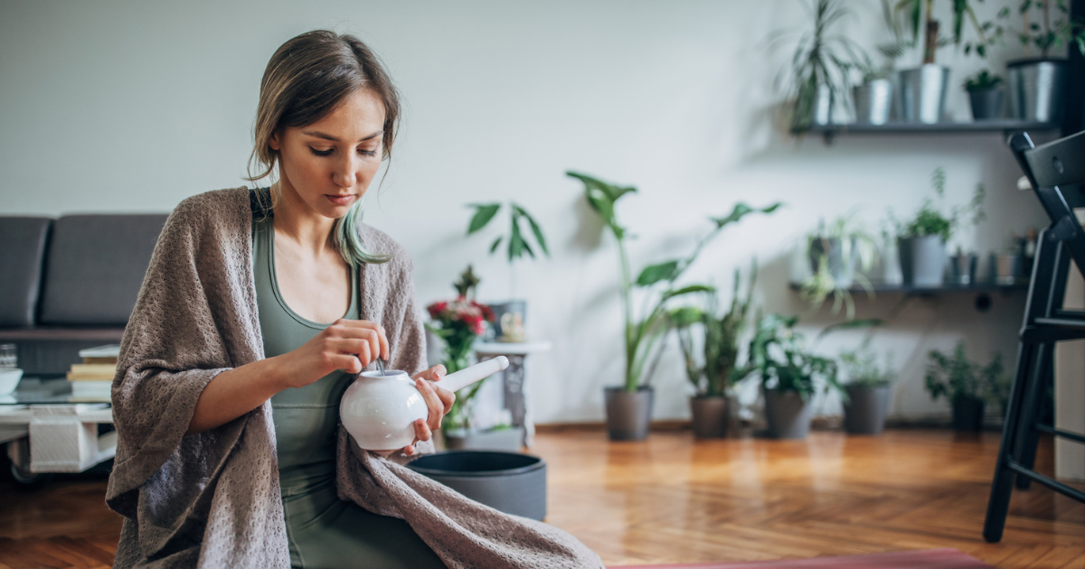 Woman holding neti pot