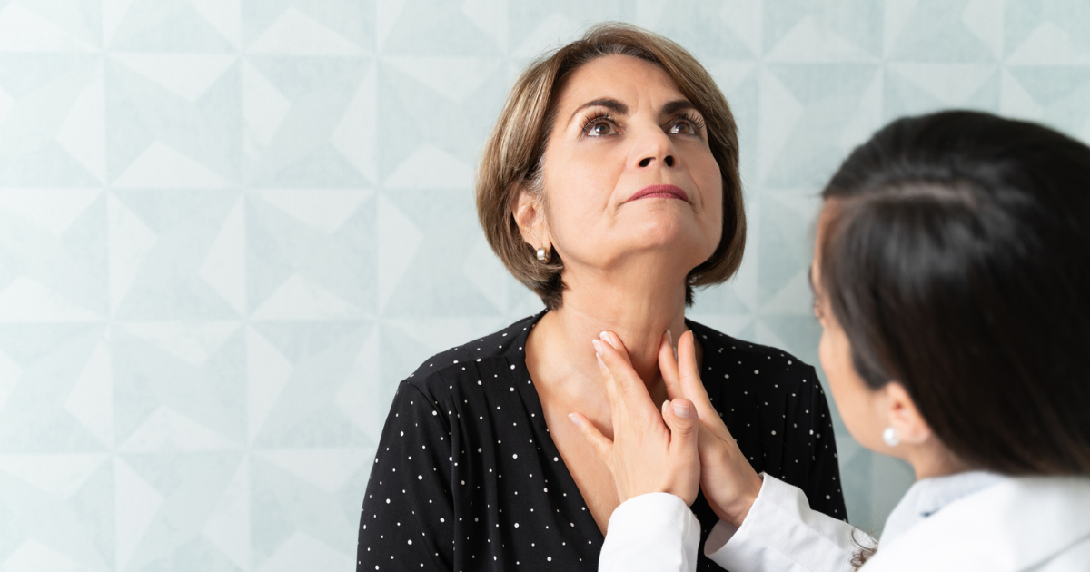 Doctor examining woman's neck