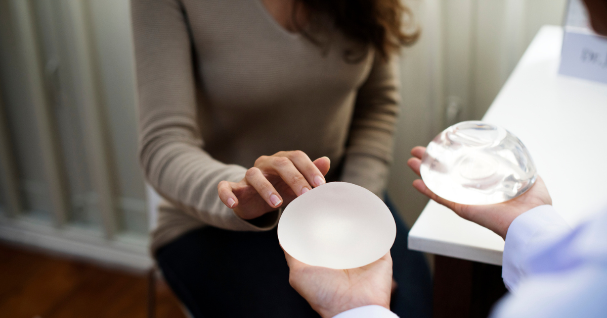 Doctor holding breast implants