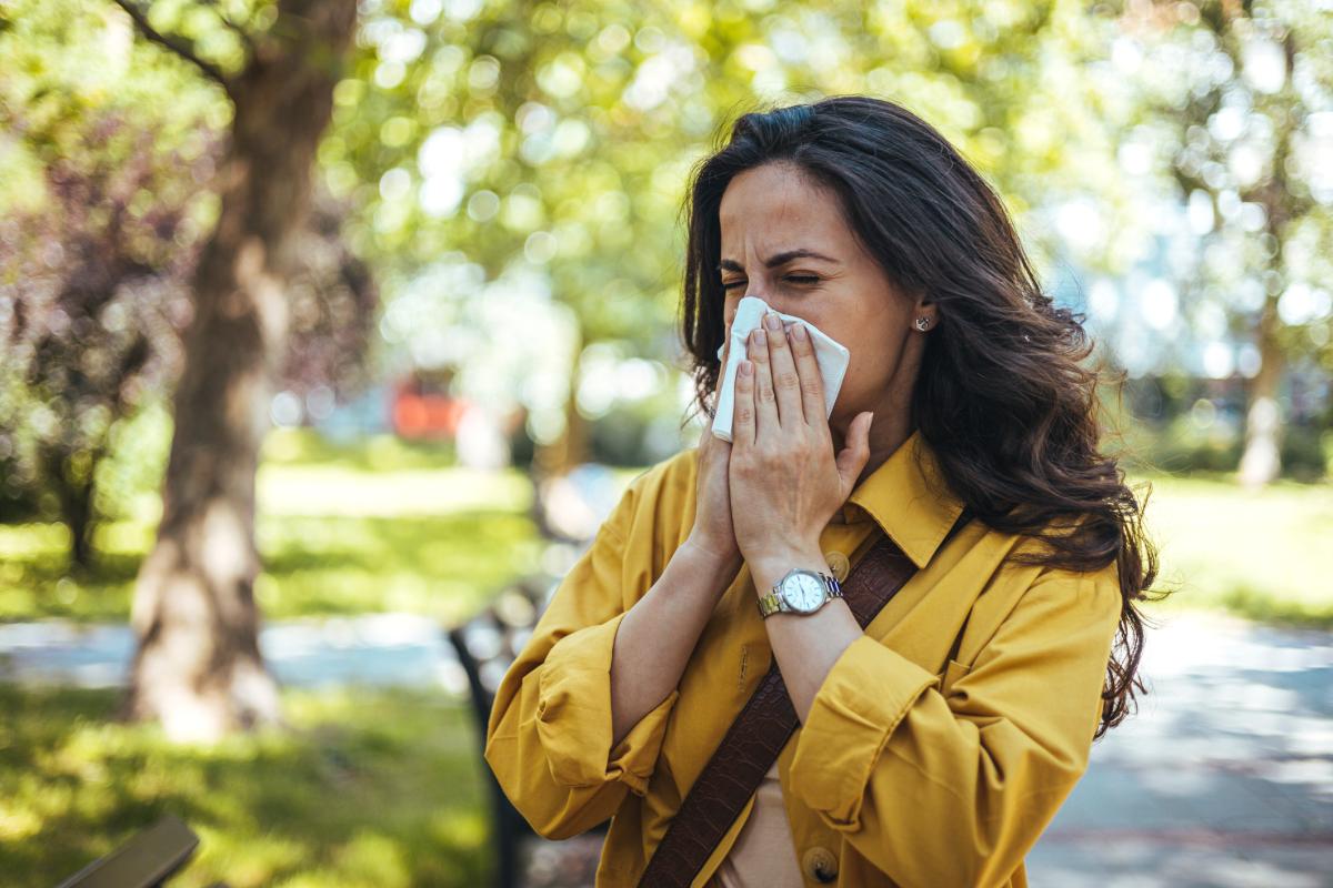 Woman blowing her nose