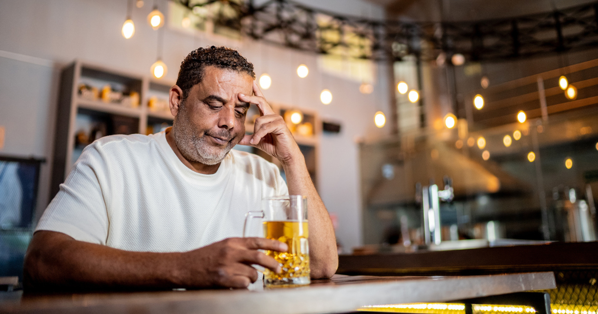 Man sitting at bar with beer