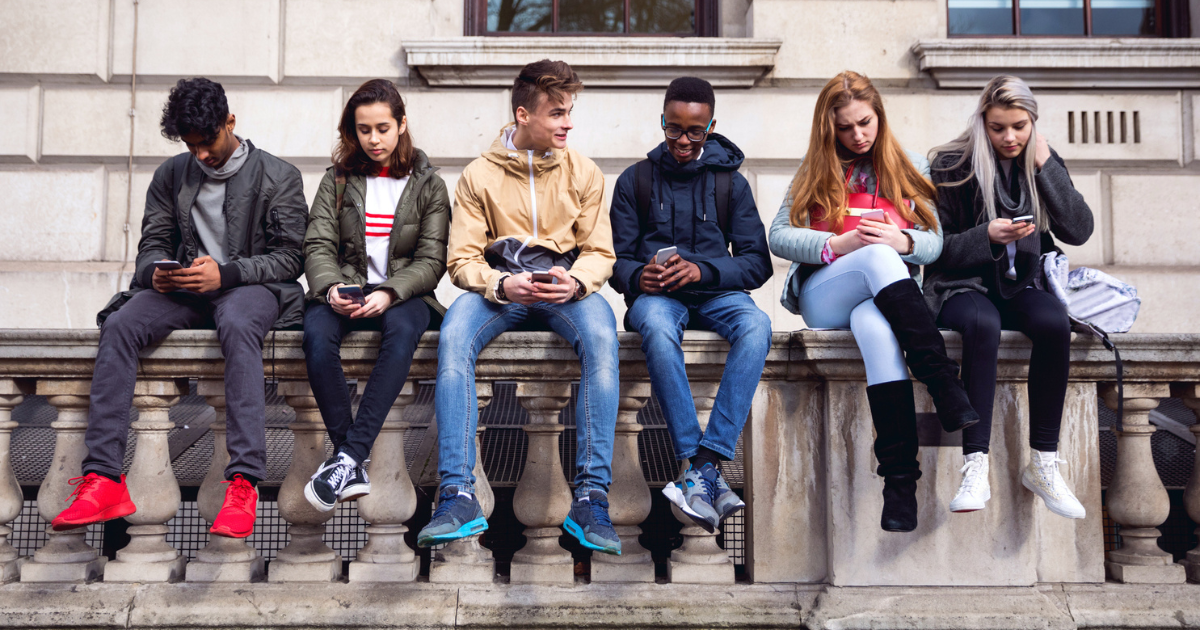 Group of teens holding cellphones