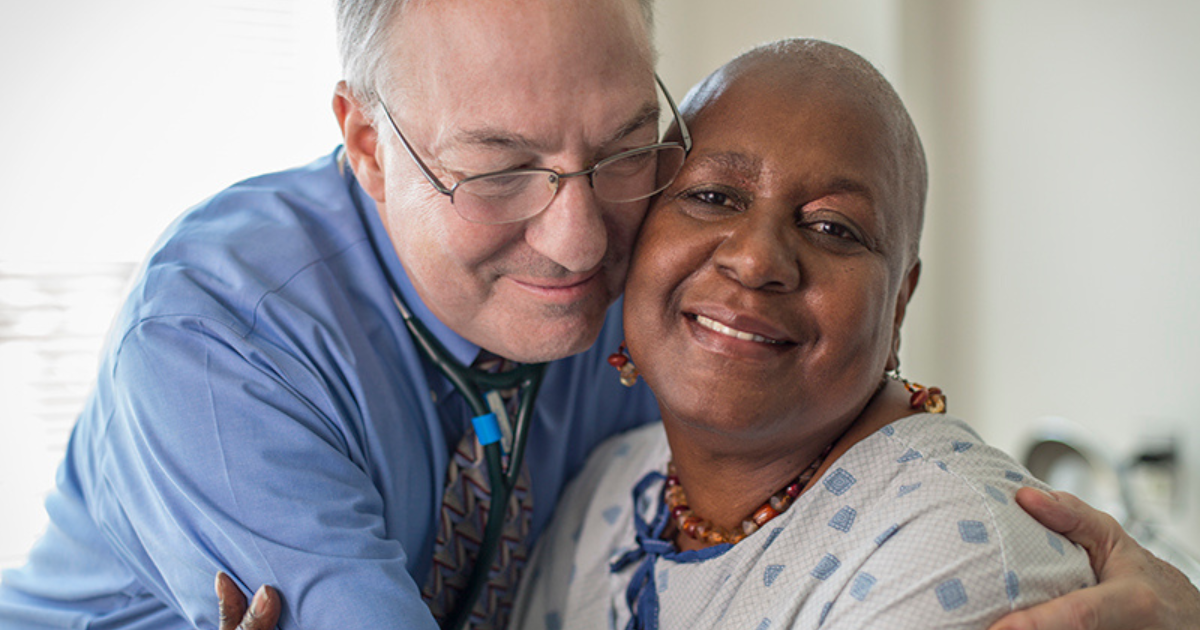 Kenneth Cowan, MD, PhD, pictured with one of his cancer patients