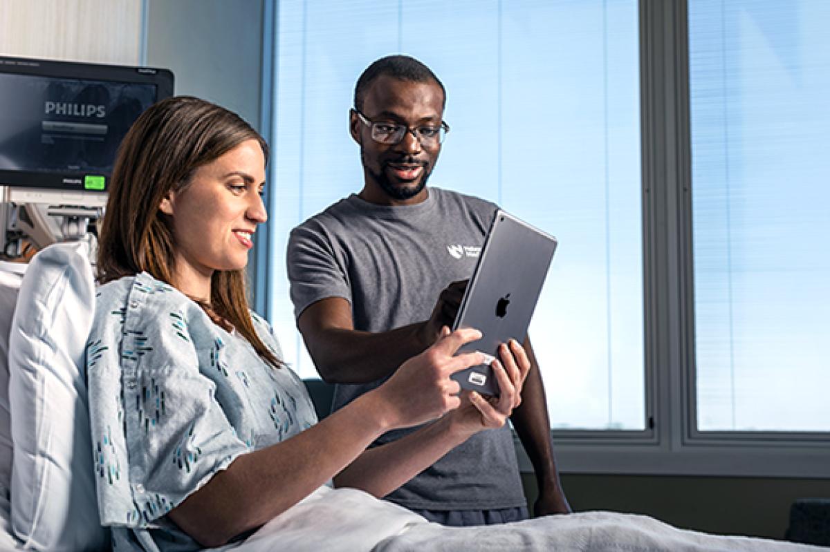 Nurse helping patient with tablet