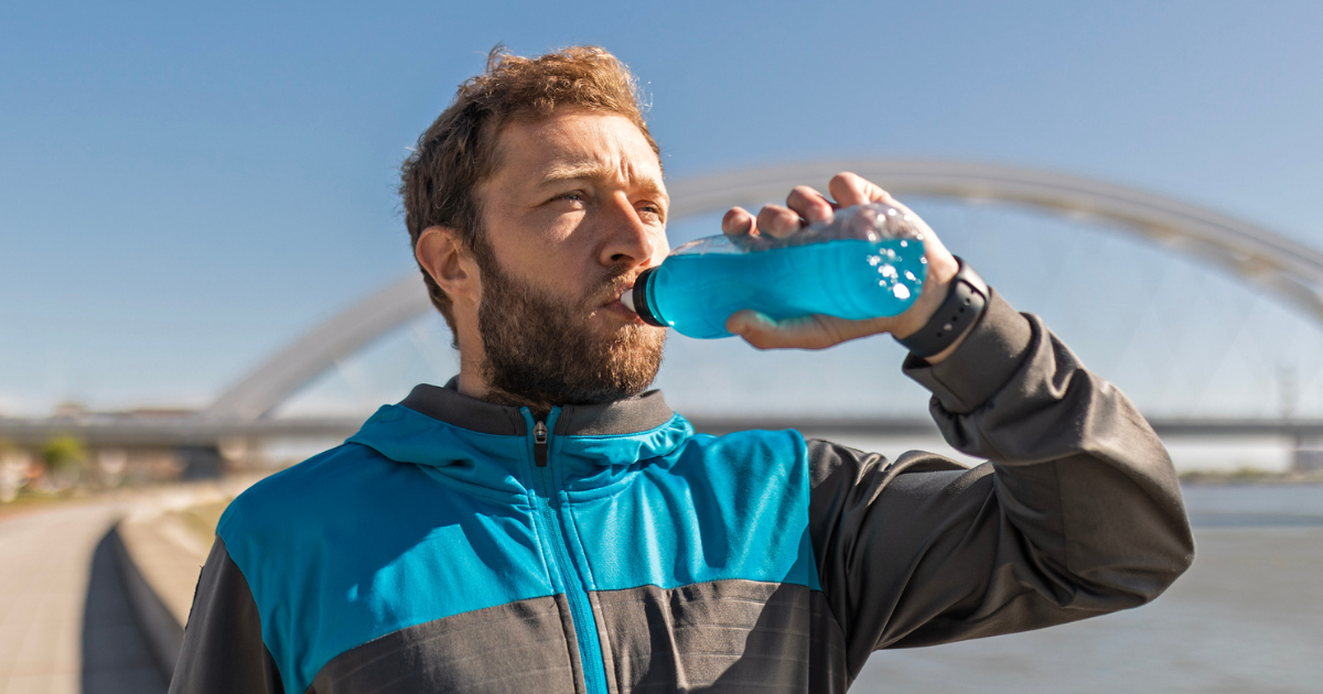 Man drinking a blue sports drink