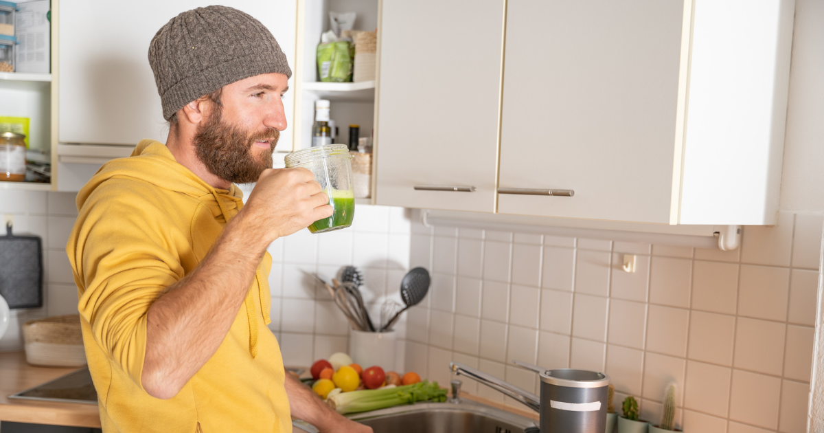 Man drinking green juice