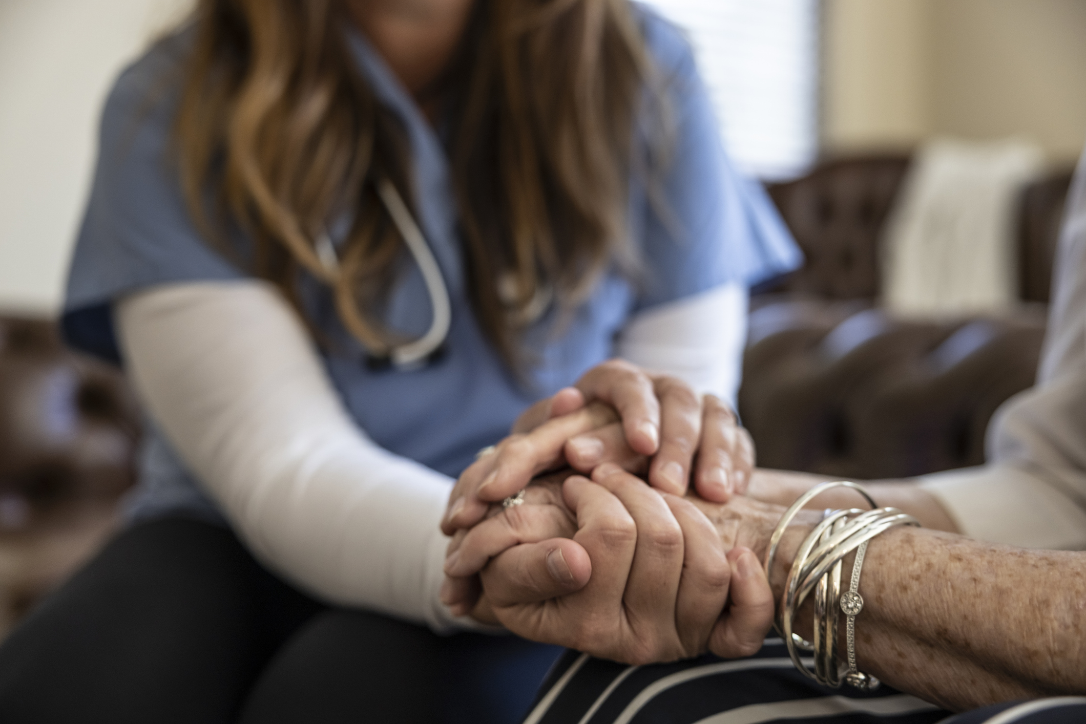 Nurse holding patient's hand