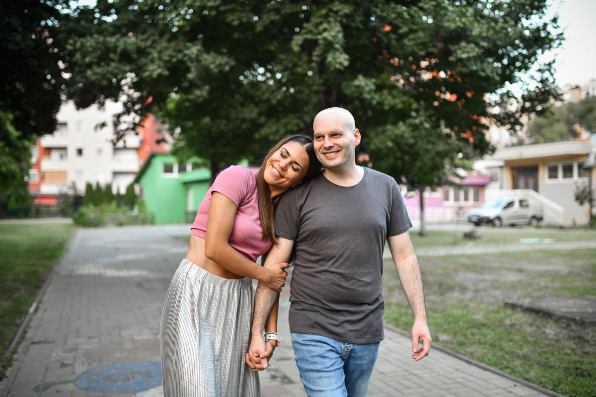 Male cancer patient walking with woman