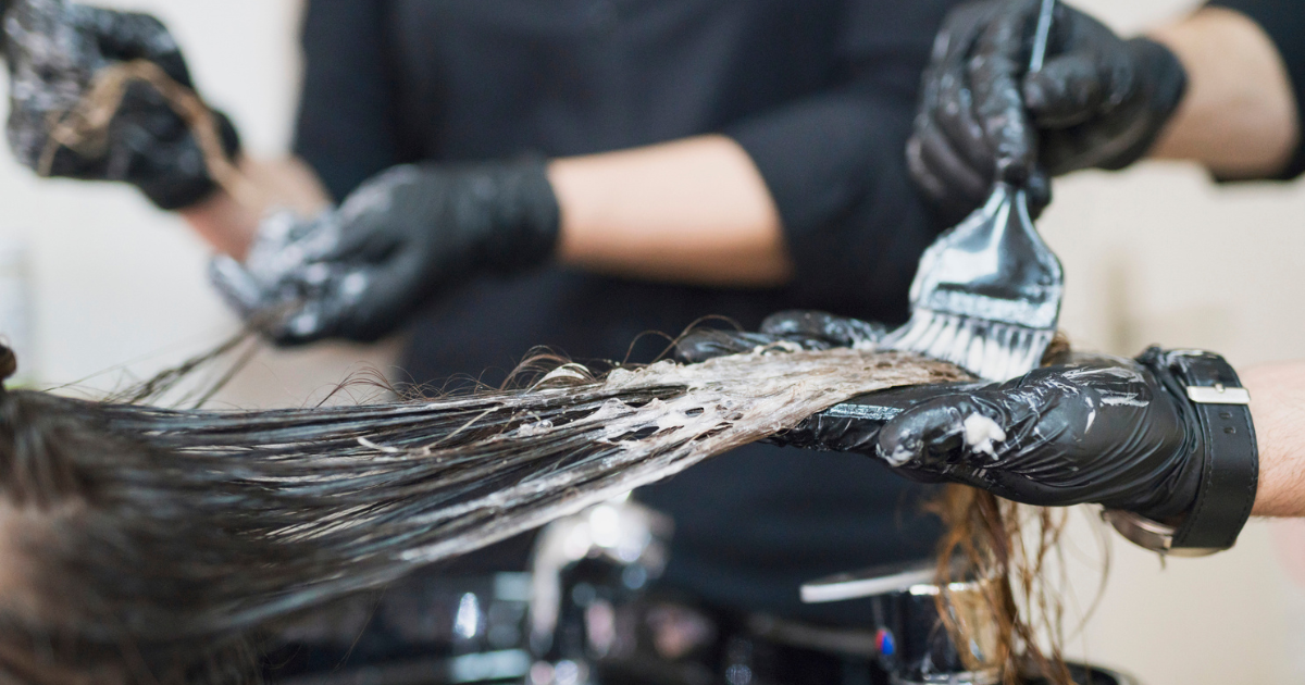 Hair stylist applying hair dye