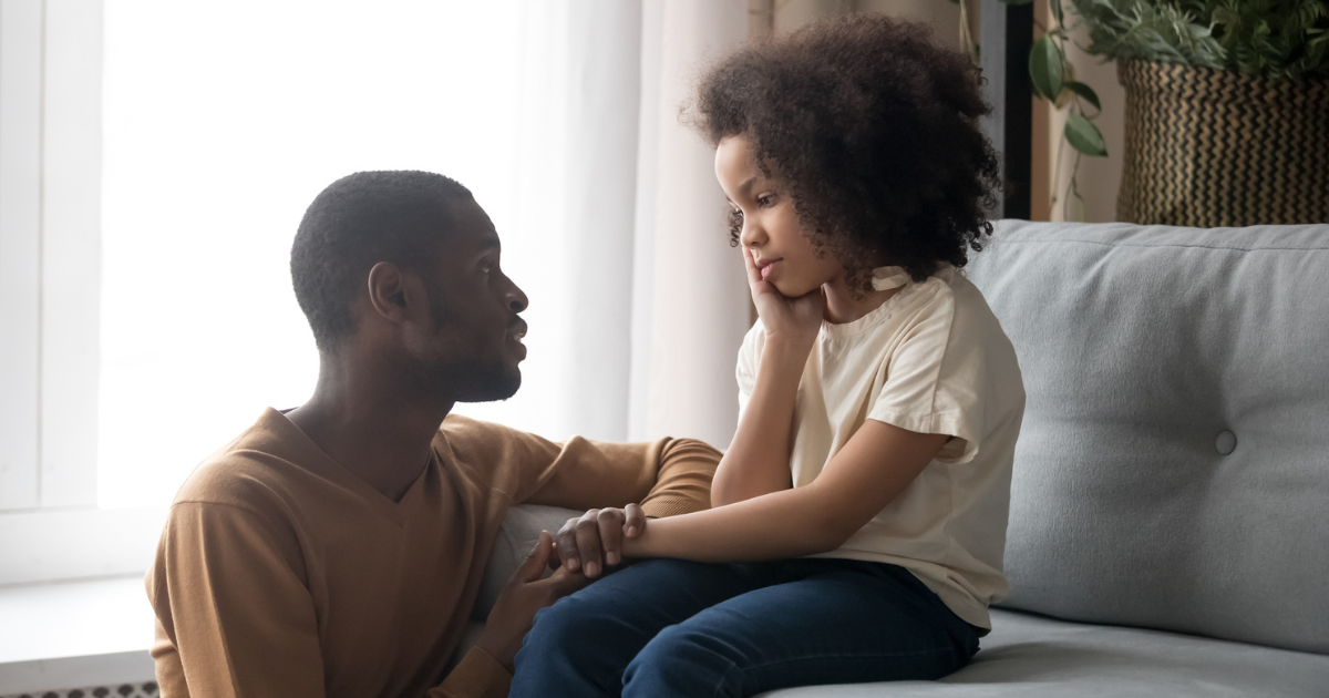 Father kneeling next to his young daughter