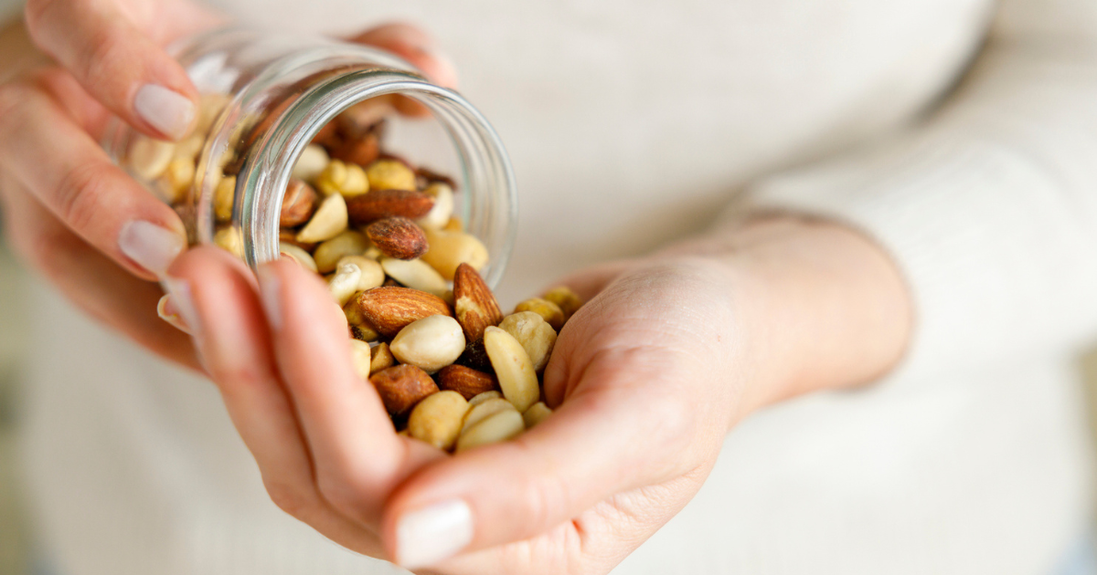 Woman pouring nuts from jar