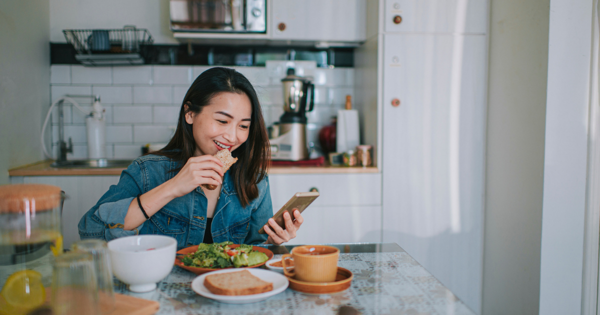 Woman eating at kitchen table