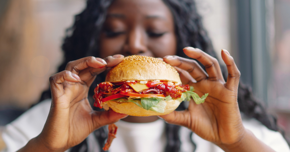 Woman holding burger