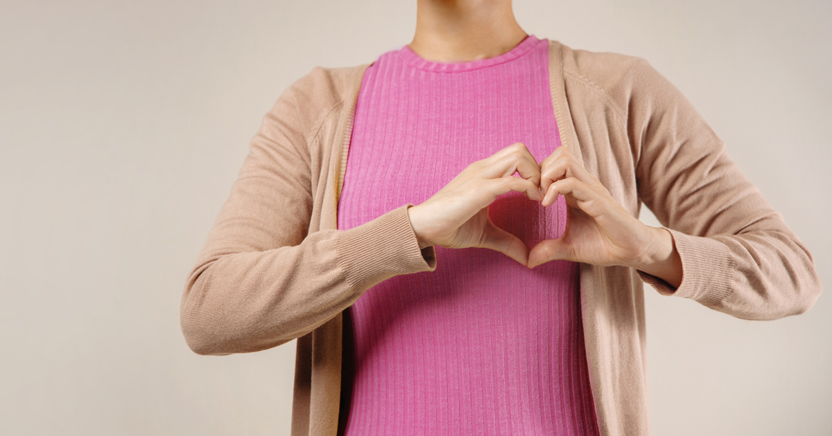 Woman making a heart with her hands in front of her chest