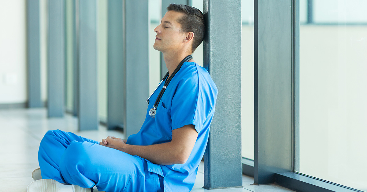 Male nurse sitting on floor