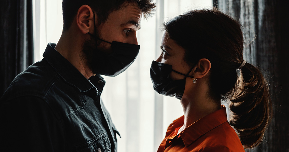 Man and woman wearing masks