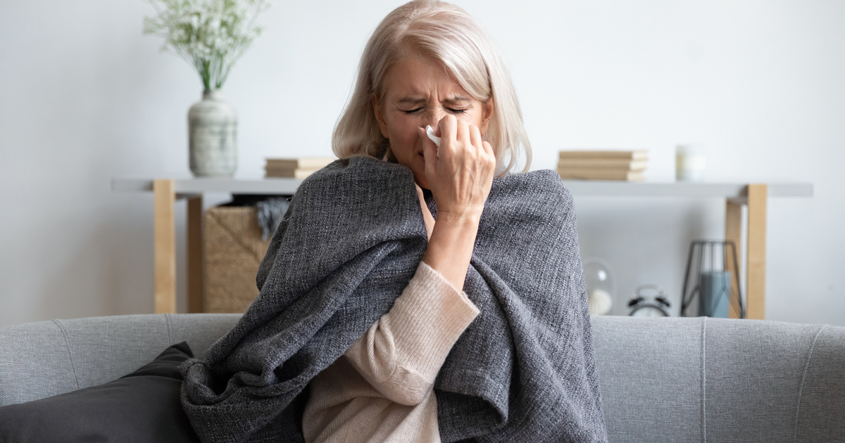 Woman blowing her nose