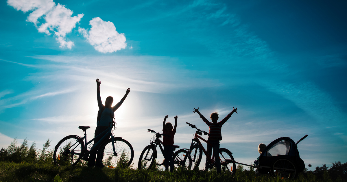 silhouetted cyclists