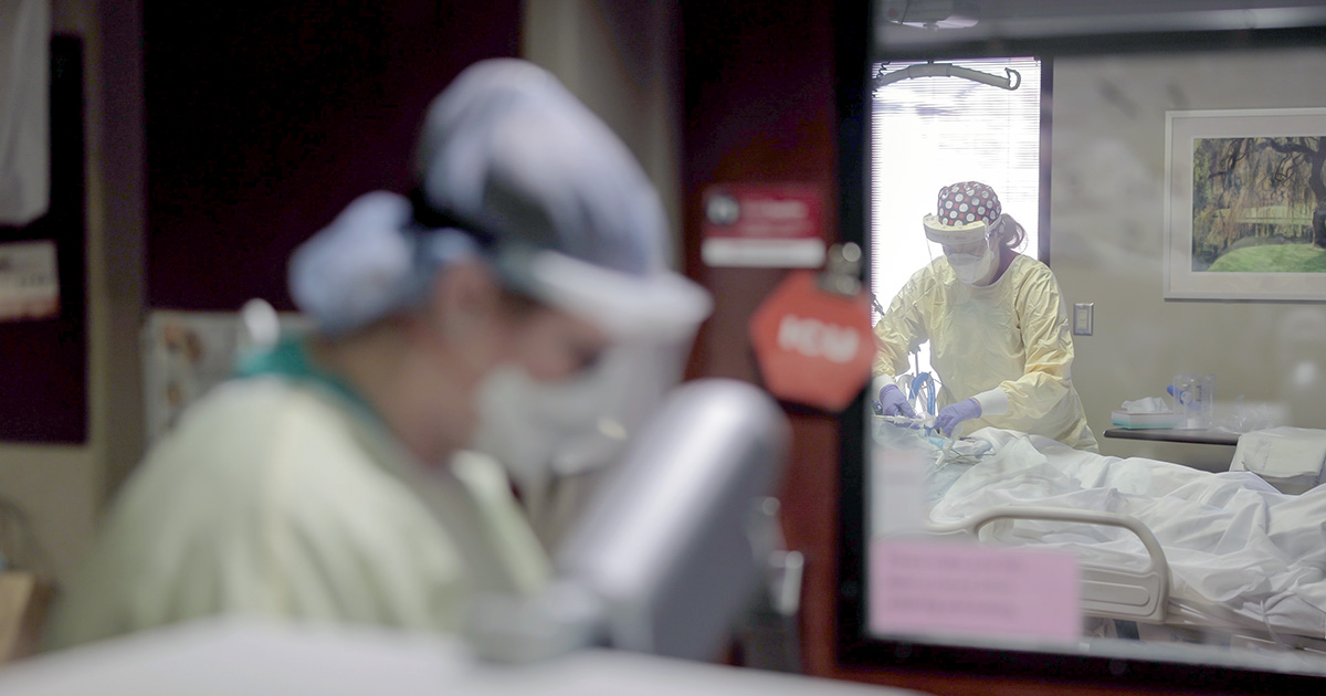 Nurses in full personal protective equipment treat COVID-19 patients at Nebraska Medical Center.