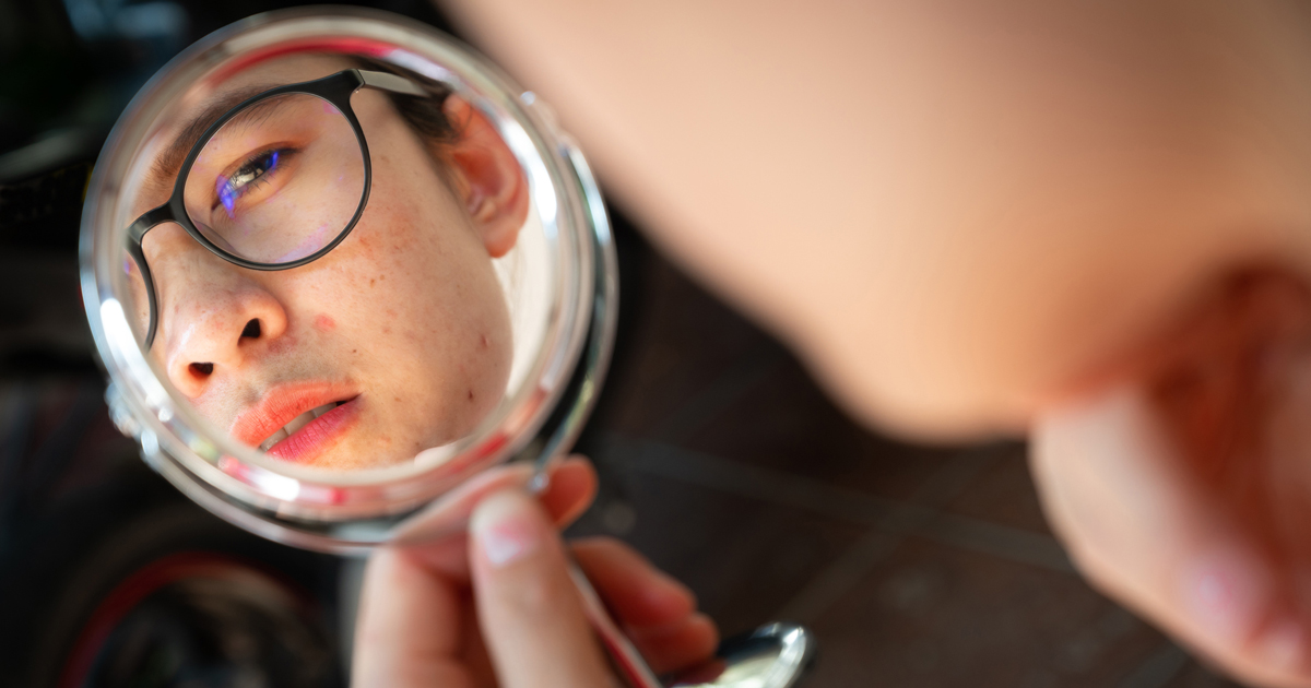 Teen boy looking in mirror