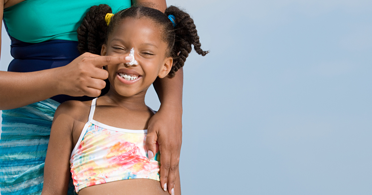 picture of a woman applying sunscreen to a child