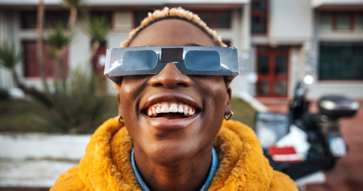 Woman wearing solar eclipse glasses