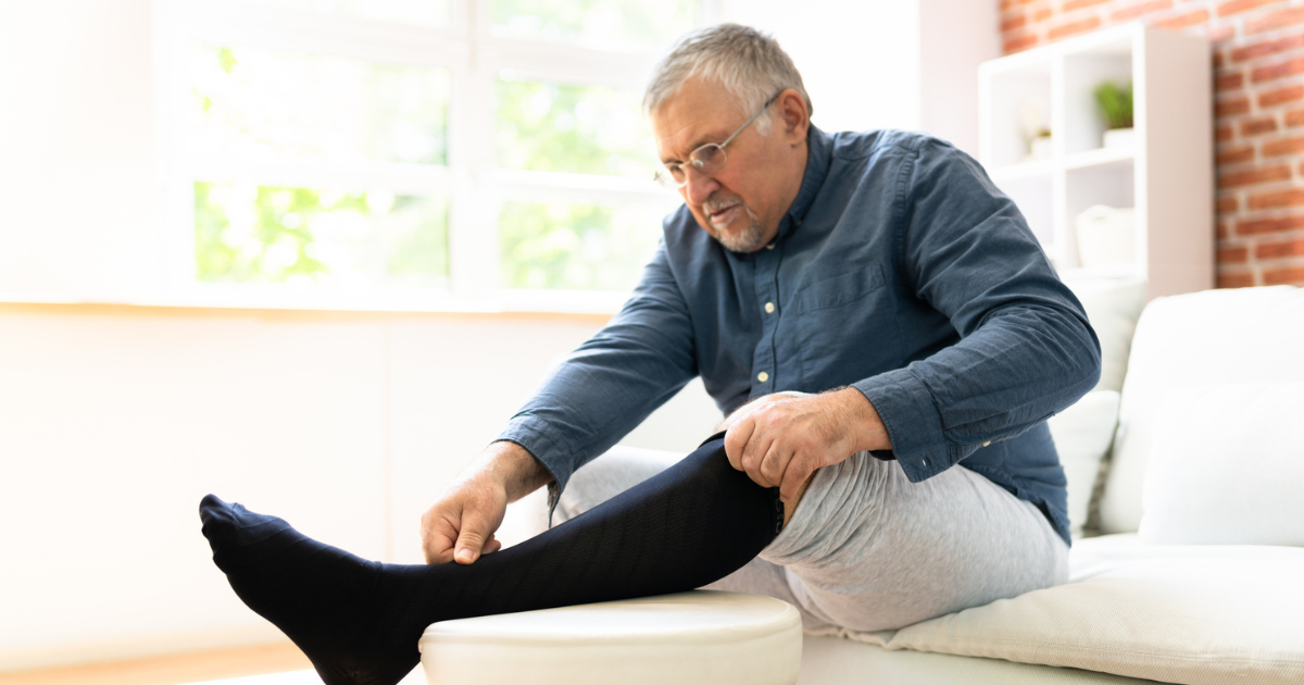 Man putting on compression stockings