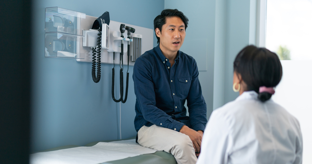 Man in doctor's office speaking to doctor