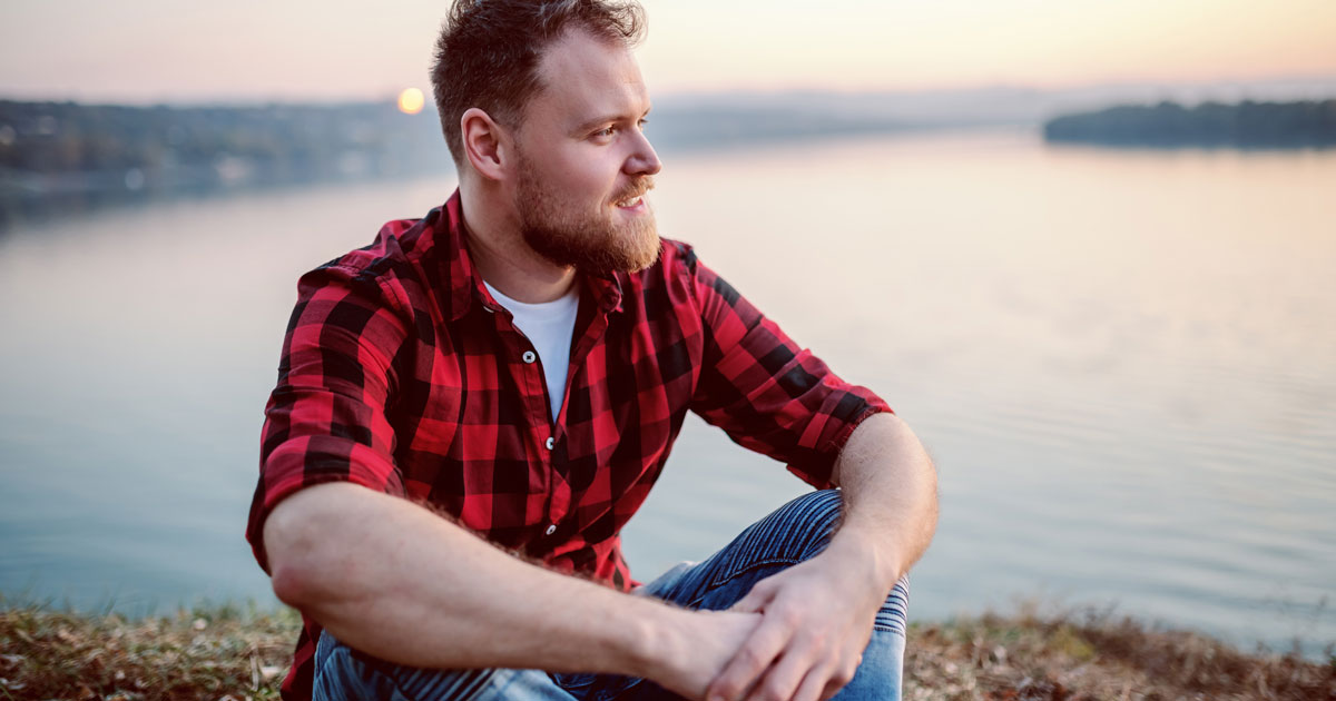 Man sitting by lake