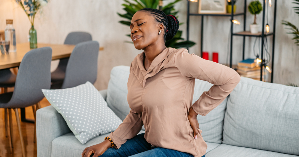 Woman holding her back in pain