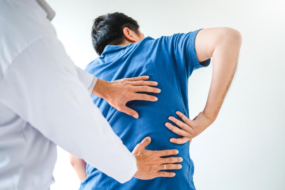 Doctor examining man's back