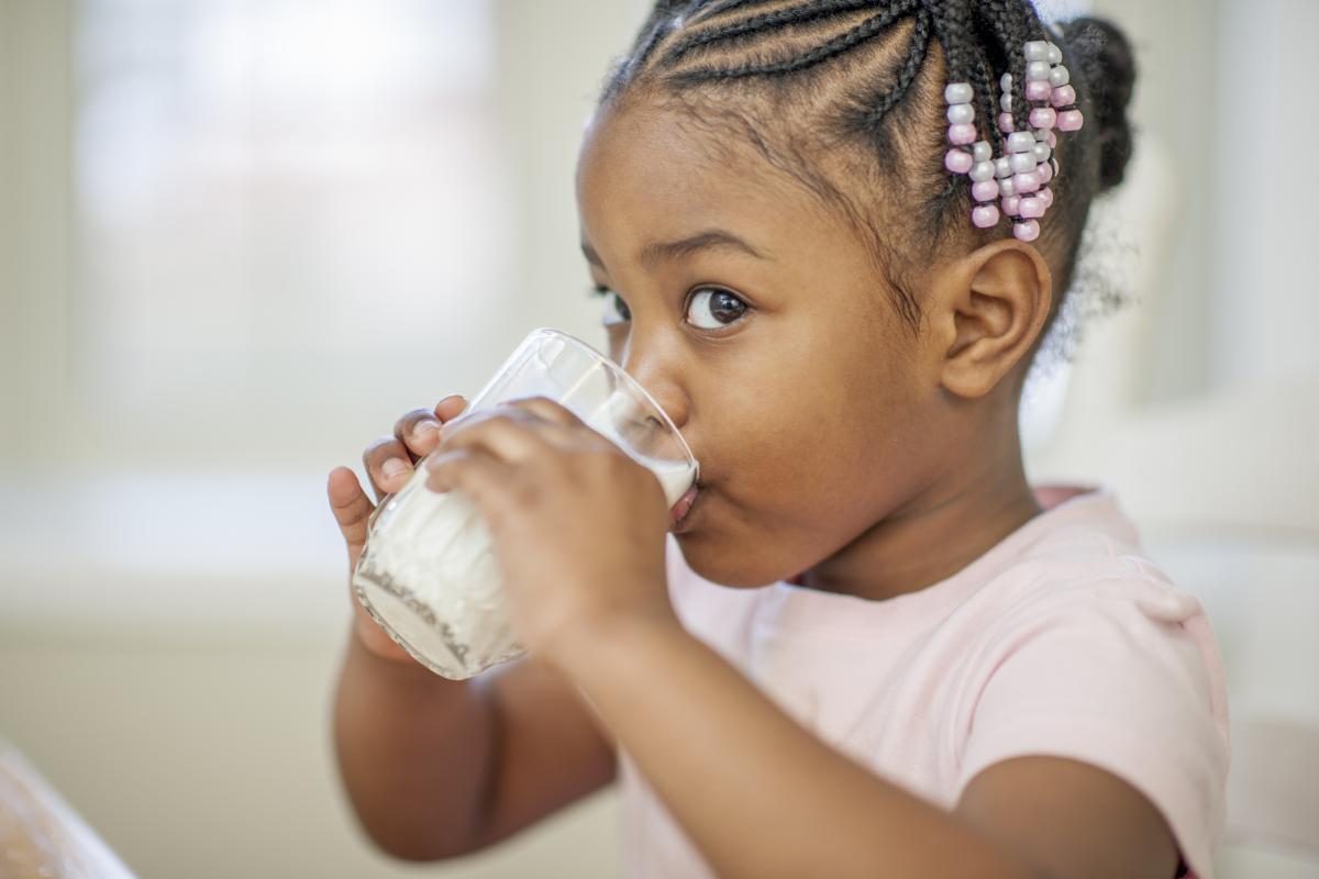 Young girl drinking milk