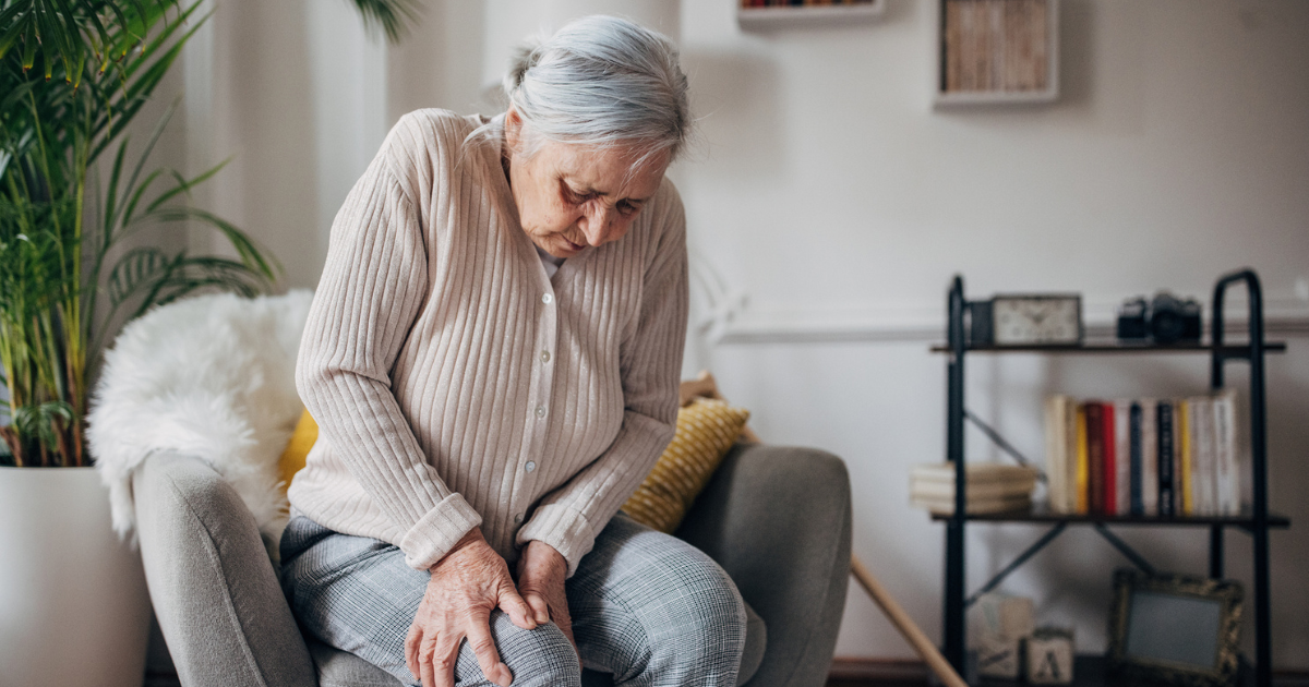 Older woman holding her knee