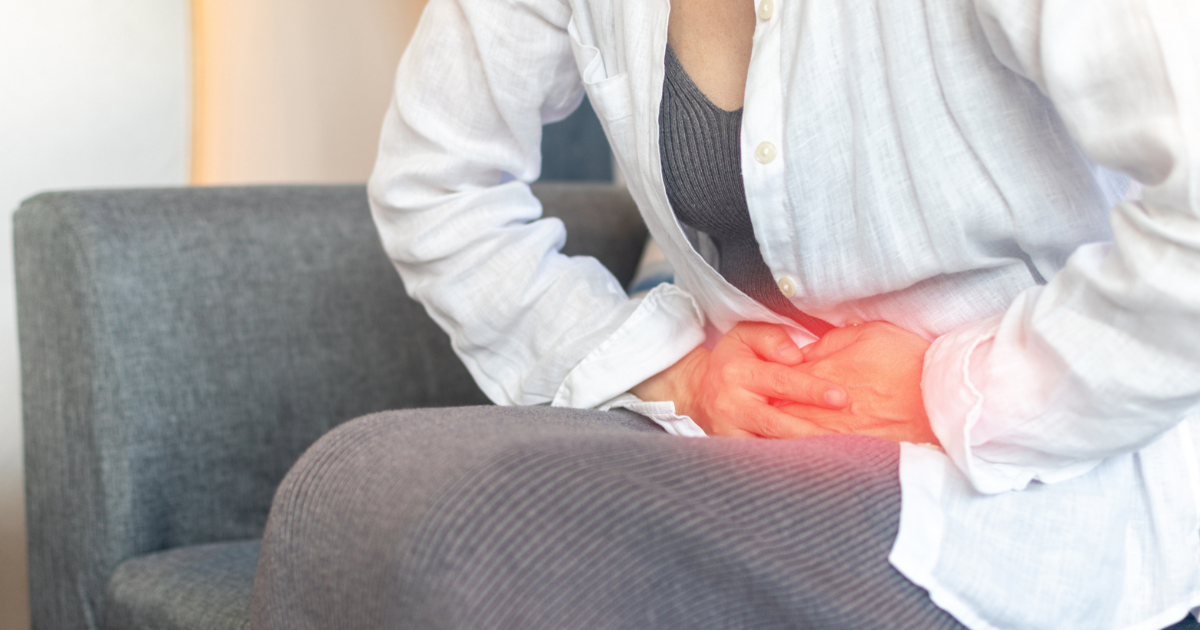 Woman grabbing her abdomen in pain