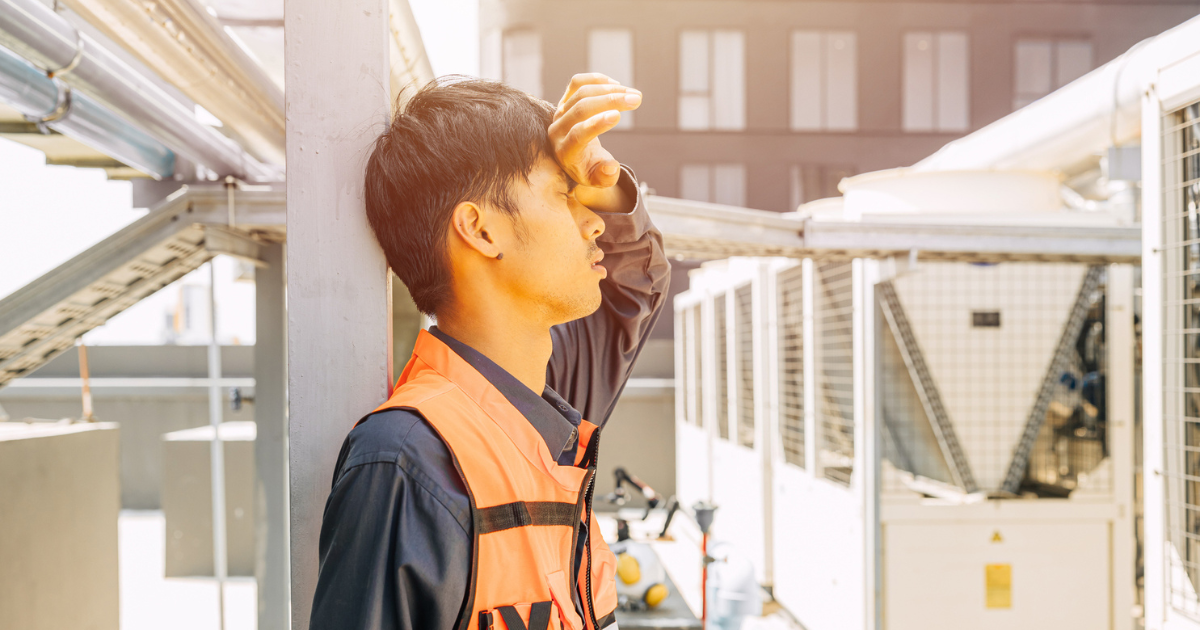 Construction worker holding his head