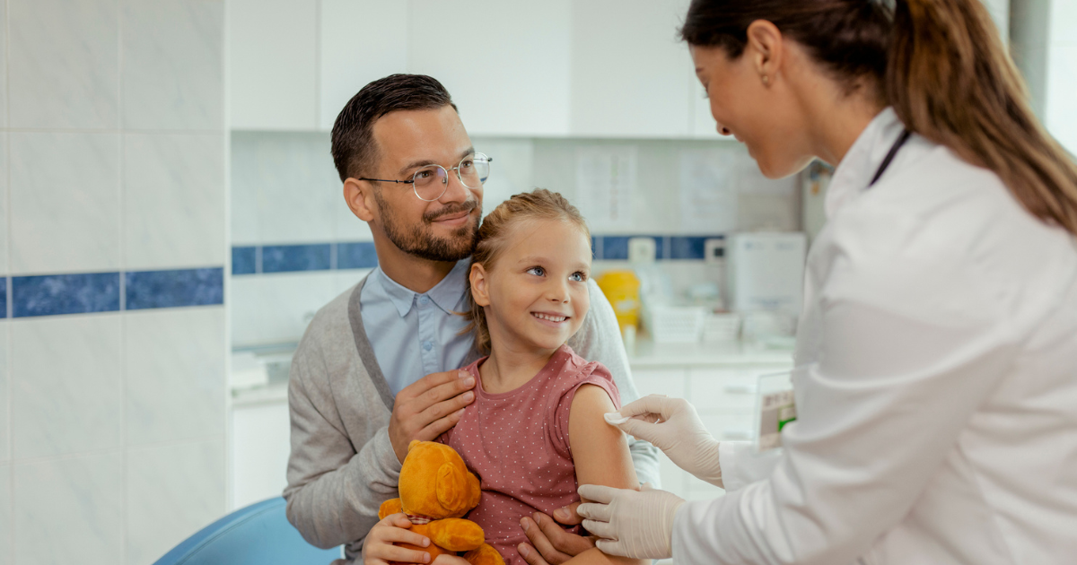 Father and young daughter getting vaccine