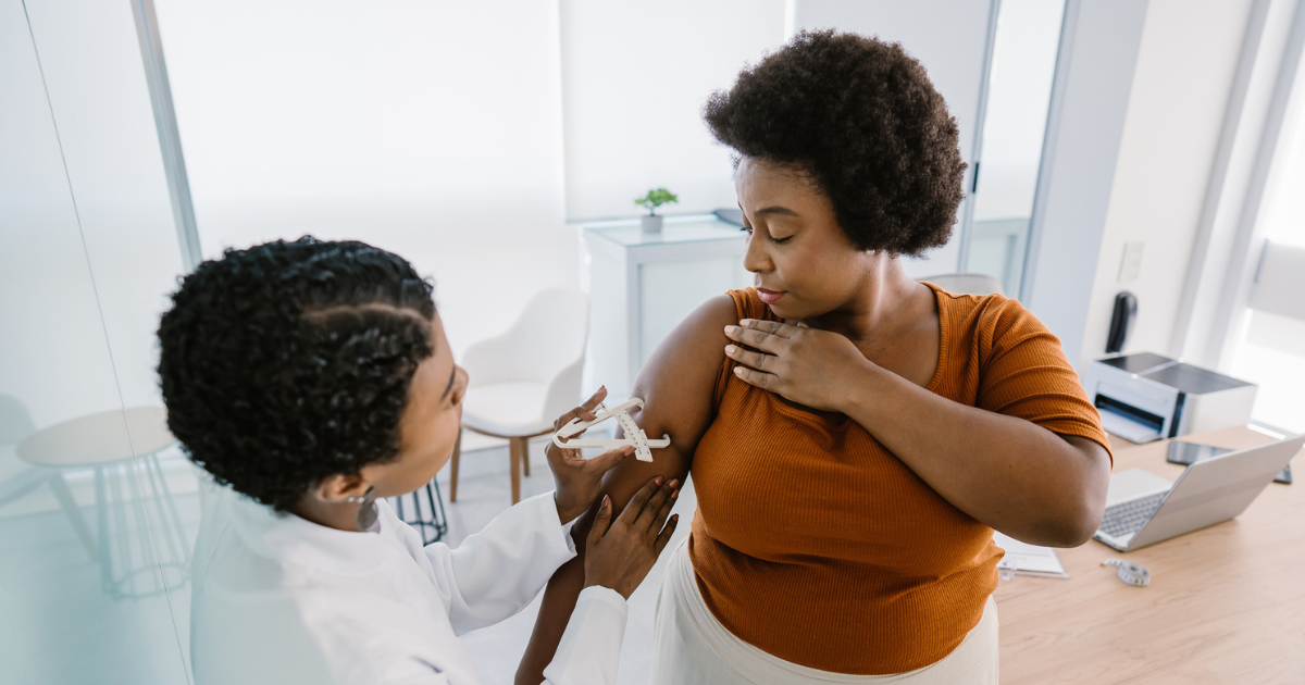 Doctor measuring woman's arm