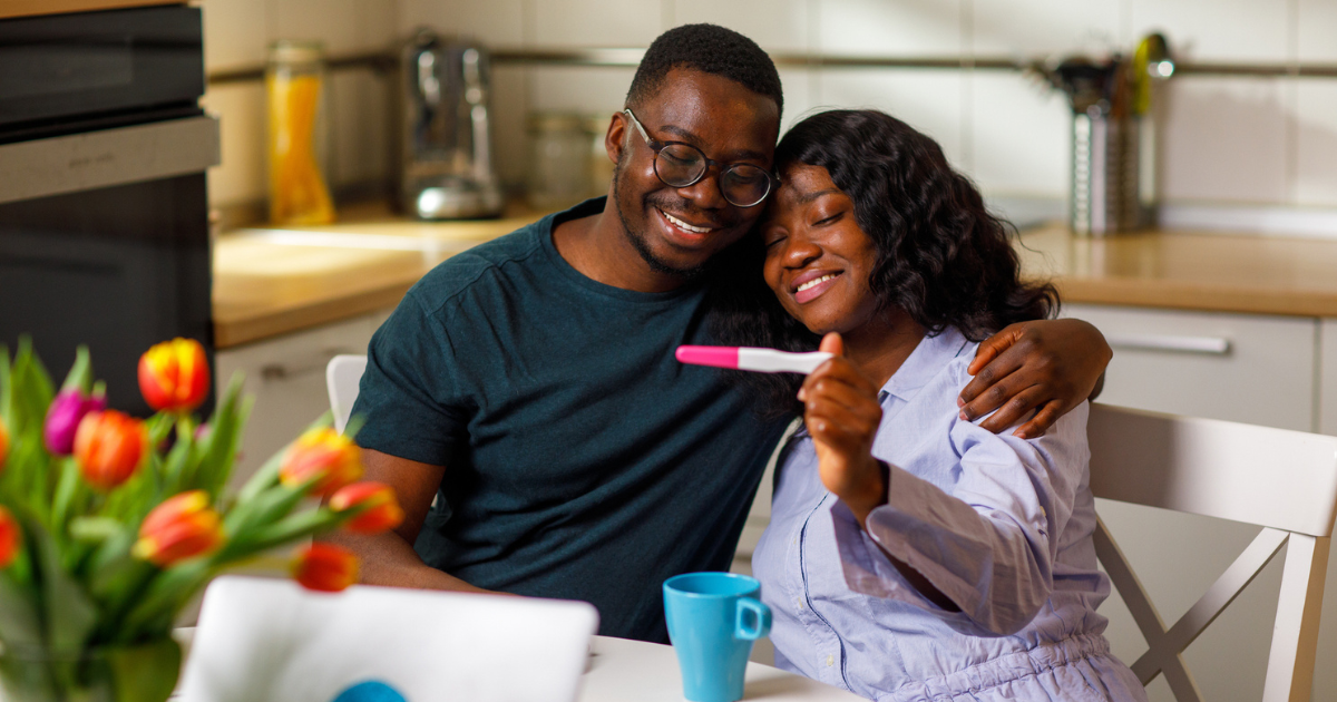 Happy couple looking at pregnancy test