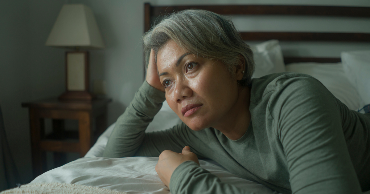 Woman lying awake in bed