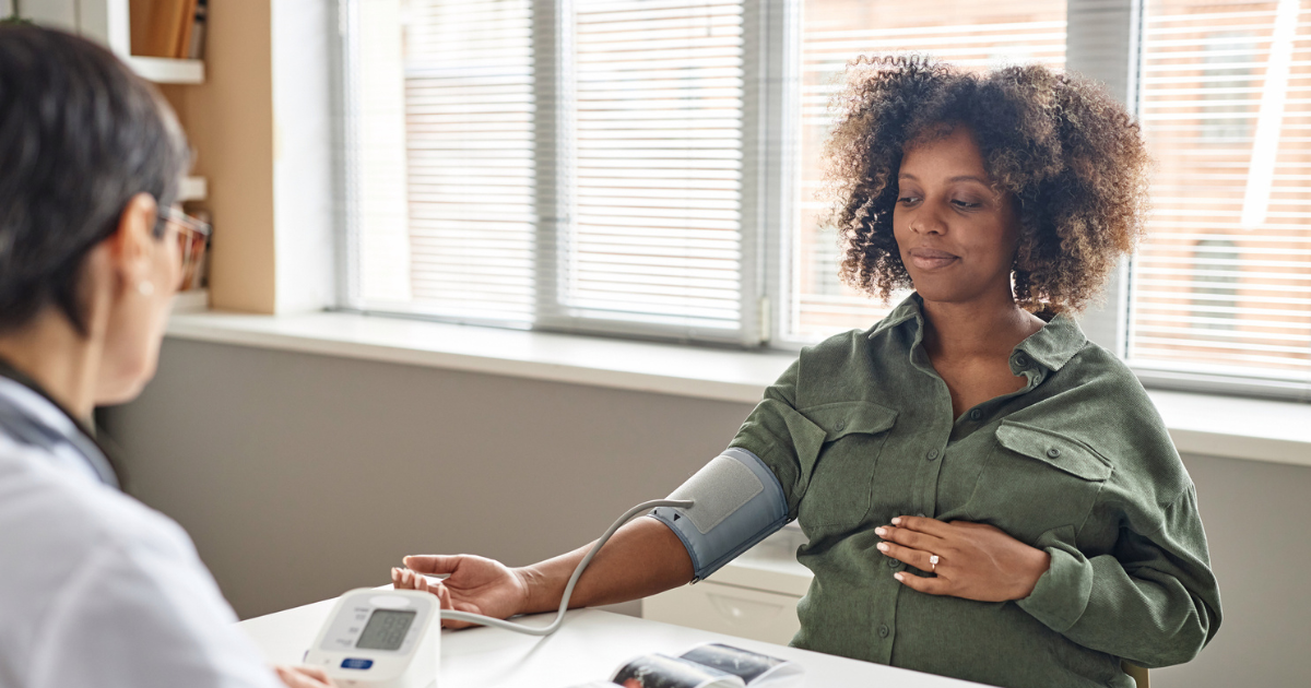 Pregnant woman getting blood pressure checked