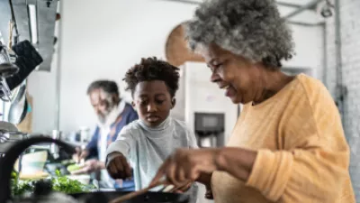 Grandmother cooking in the kitchen with her grandson