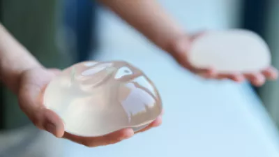 Hands holding saline breast implants