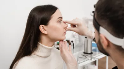 Doctor evaluating a woman's nose for a rhinoplasty