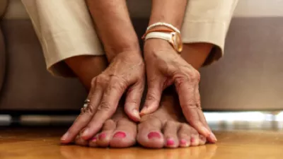 Close up of a woman holding her feet