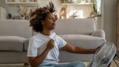 Woman sitting in front of a fan