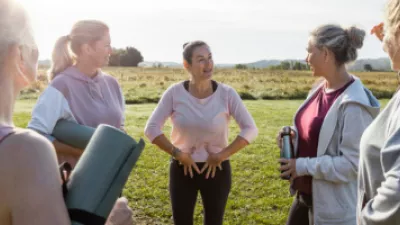 Group of women holding yoga mats