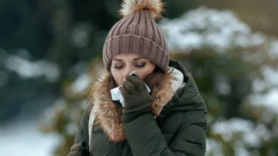 Woman blowing her nose