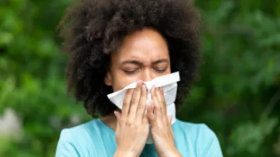 Woman blowing her nose