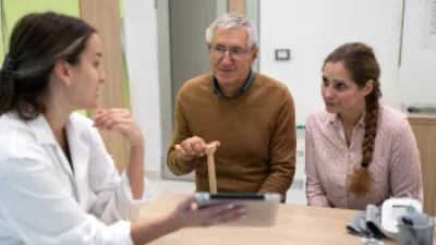 Man and his adult daughter speaking to doctor