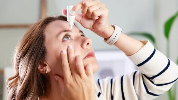 Woman putting in eye drops